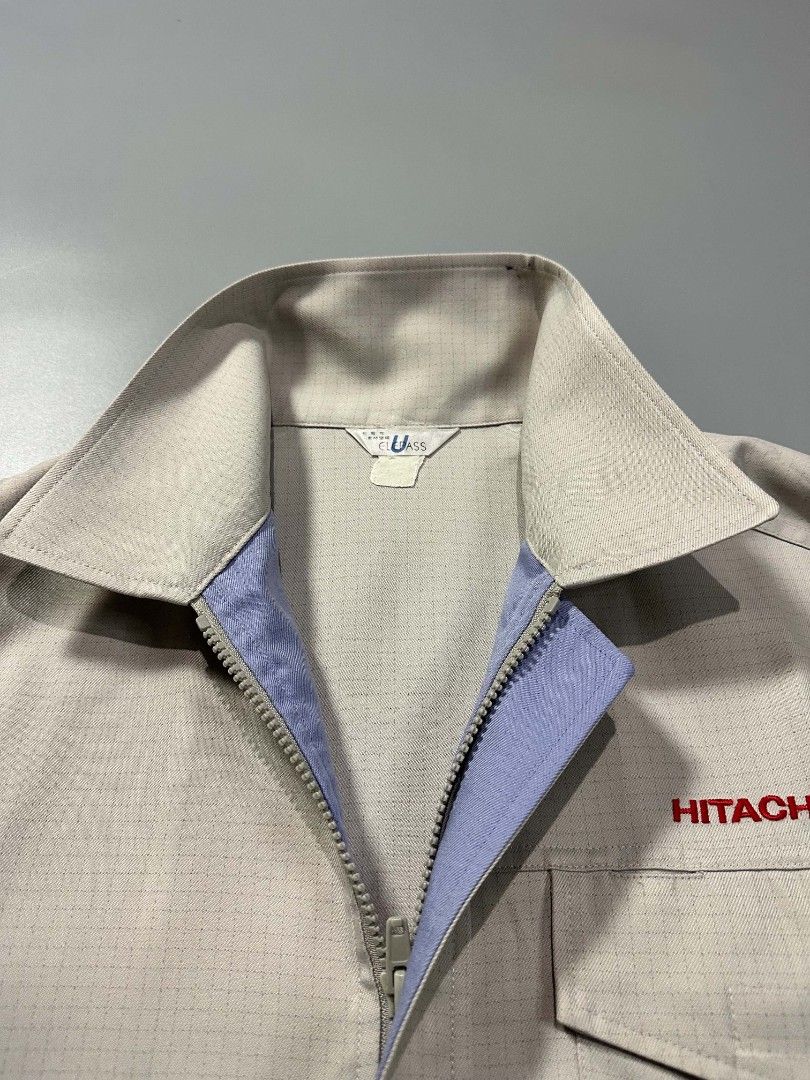 Hitachi Corporate Work Jacket Light Grey Utility Outerwear (Category: Coats, Jackets and Outerwear) located in Manila. Submitted by whoego (Listing ID 1470122615, Image 2). Description: - Brand: Hitachi Length: 27.5 inches Width: 25.2 inches Shoulders: 21.3 inches Sleeves: 10.5 inches - Color: Light grey with blue inner collar and red embroidered chest logo - Style: Zip-up work jacket with stand collar and elasticated back hem - Pockets: Front fl