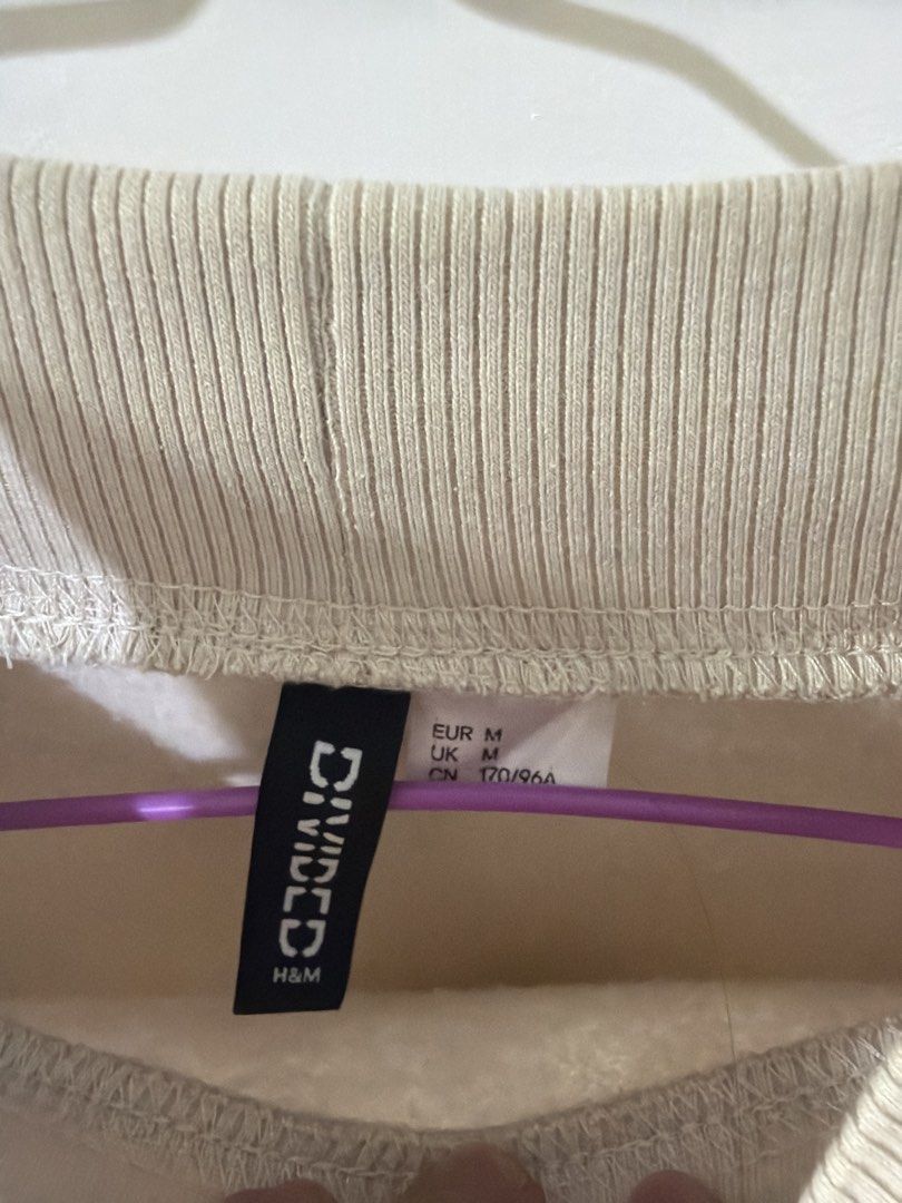 H&M Divided Paris Colorblock Sweatshirt Size M (Category: Longsleeves) located in Rizal. Submitted by kyliemaine (Listing ID 1470014504, Image 2). Description: - Brand/Model: H&M Divided Colorblock Sweatshirt - Colorway: Beige, white, and blue - Design: Bold 'PARIS FRANCE' lettering on the chest - Fit: Relaxed, oversized fit with drop shoulders - Details: Mock neck collar, ribbed cuffs and hem - Interior: Soft fleece lining for extra warmth - Siz