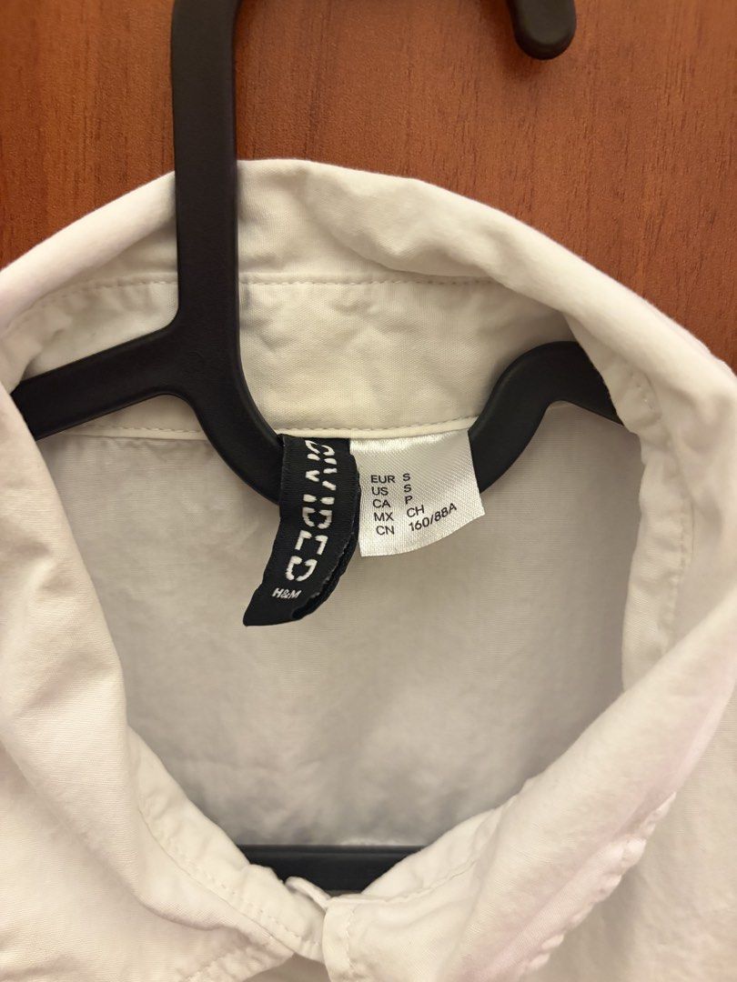 H&M Divided White Button-Down Shirt (Category: Shirts) located in Makati City. Submitted by chloudyday (Listing ID 1470064481, Image 2). Description: H&M Divided, Size S (but can fit M), Relaxed Fit Issue (Last Photo): Barely noticeable yellow stain near the button area..