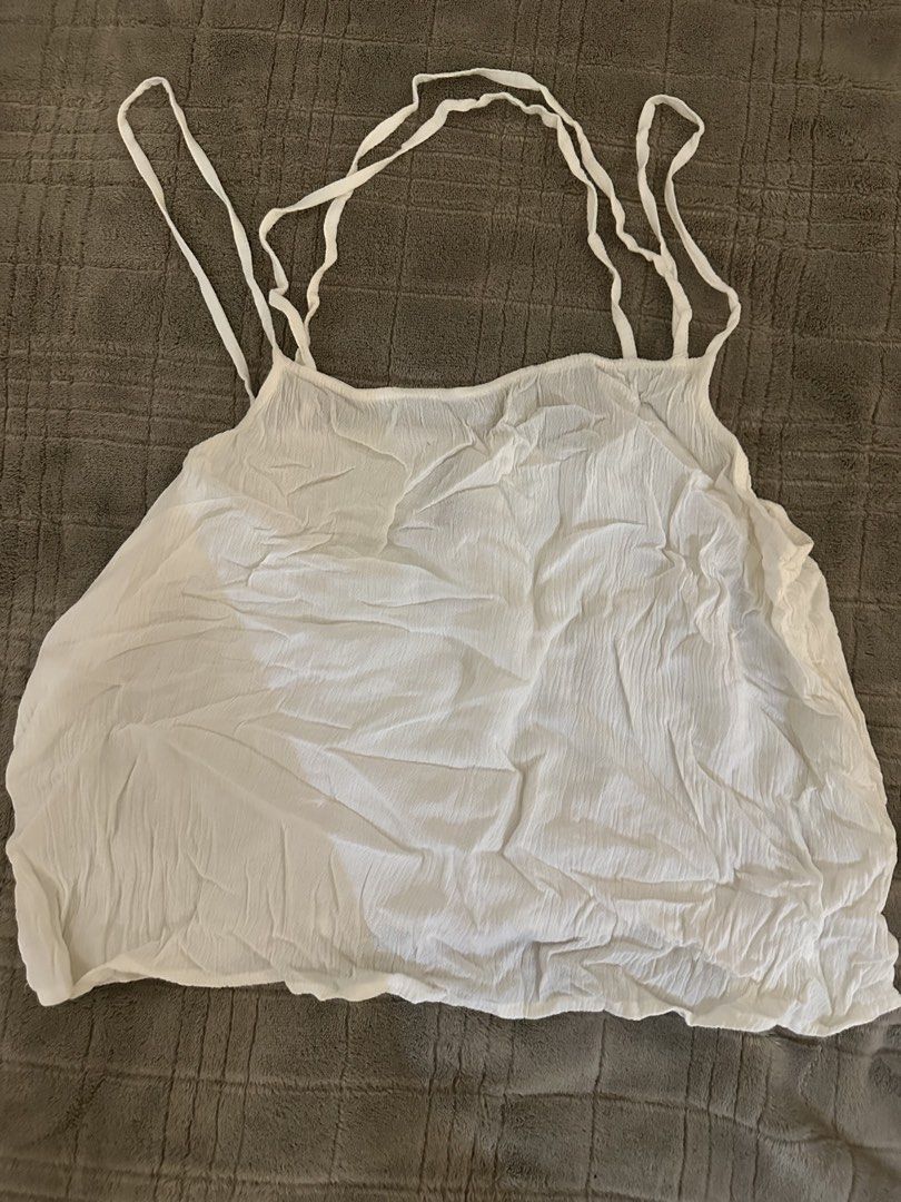H&M Divided White Cami Tank Top Size S (Category: Sleeveless) located in Manila. Submitted by cabuniagpr58494 (Listing ID 1470077392, Image 1). Description: - Brand: H&M Divided - Size: EUR 38 / US S / 160/88A - Color: Classic White - Material: Lightweight textured fabric with a trendy crinkled look - Design: Loose, relaxed fit with chic multiple thin strap details on the back - Versatility: Great for layering or wearing on its own on warm days.