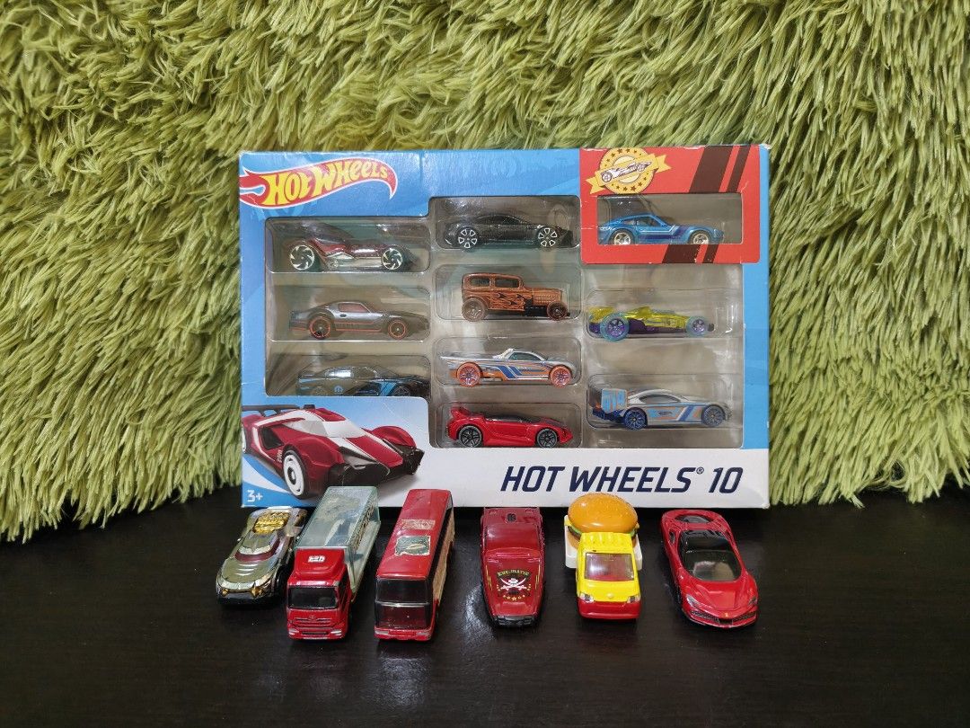 Hot Wheels 10 Car Gift Pack Box Set (Category: Vehicle & Diecast Models) located in La Trinidad. Submitted by charlsensei (Listing ID 1469964421, Image 2). Description: - Hot Wheels 10-car die-cast multipack box set - Includes extra loose cars: Tomica truck, double-decker bus, and burger car - Condition: Outer box has minor corner wear and creases from storage - Ideal for toy car collectors and kids - PM for more details or shipping options.