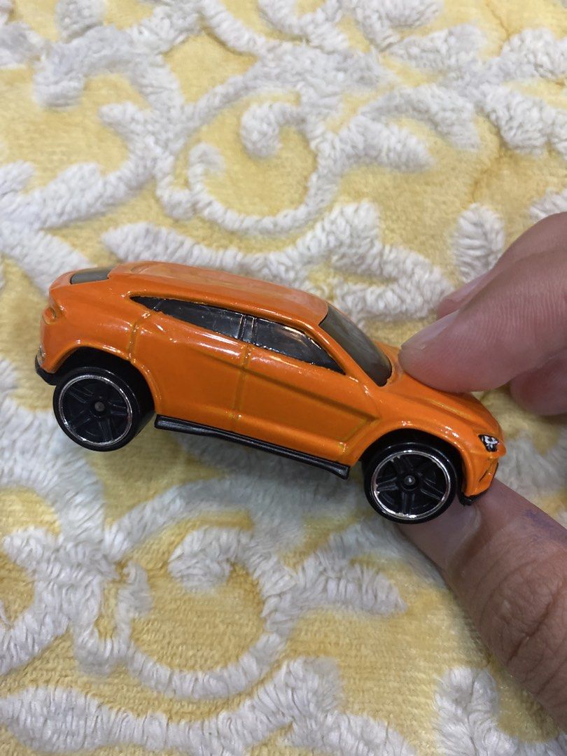 Hot Wheels Lamborghini Urus Orange Toy Car (Category: Vehicle & Diecast Models) located in Manila. Submitted by j9e0fri_2025 (Listing ID 1470102582, Image 2). Description: - Brand: Hot Wheels - Model: Lamborghini Urus - Color: Vibrant orange with black wheels and black base - Material: Solid diecast build - Origin: Made in Malaysia - Stamp: 2014 Mattel & Lamborghini Urus - Condition: Great for collectors and kids' play.