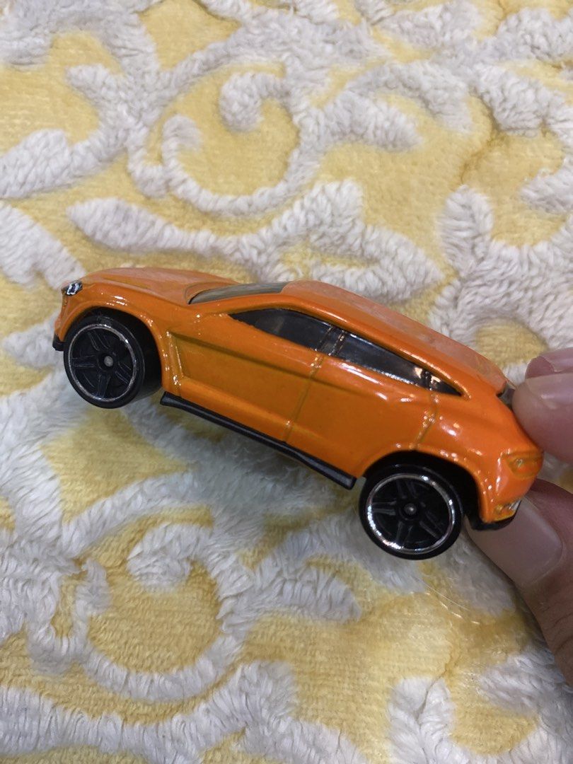 Hot Wheels Lamborghini Urus Orange Toy Car (Category: Vehicle & Diecast Models) located in Manila. Submitted by j9e0fri_2025 (Listing ID 1470102582, Image 3). Description: - Brand: Hot Wheels - Model: Lamborghini Urus - Color: Vibrant orange with black wheels and black base - Material: Solid diecast build - Origin: Made in Malaysia - Stamp: 2014 Mattel & Lamborghini Urus - Condition: Great for collectors and kids' play.