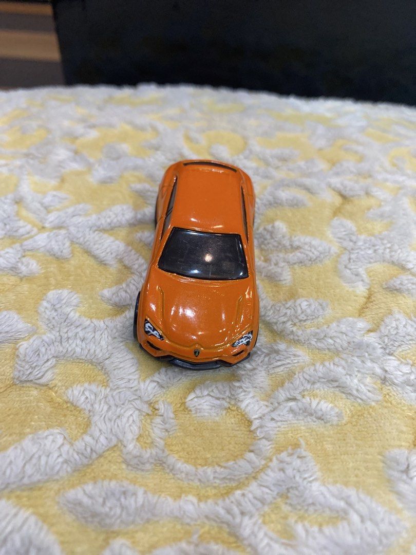 Hot Wheels Lamborghini Urus Orange Toy Car (Category: Vehicle & Diecast Models) located in Manila. Submitted by j9e0fri_2025 (Listing ID 1470102582, Image 1). Description: - Brand: Hot Wheels - Model: Lamborghini Urus - Color: Vibrant orange with black wheels and black base - Material: Solid diecast build - Origin: Made in Malaysia - Stamp: 2014 Mattel & Lamborghini Urus - Condition: Great for collectors and kids' play.