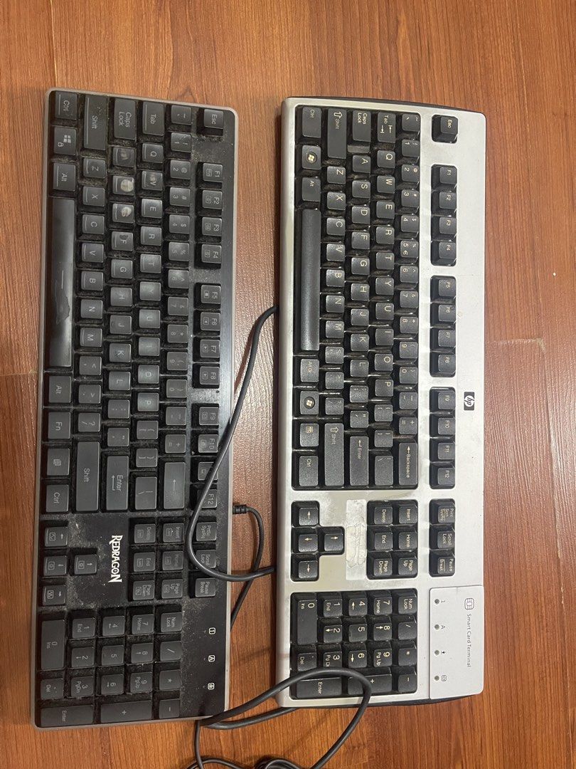 HP and Redragon Keyboards Bundle (Category: Computer Keyboard) located in Manila. Submitted by ljbalza (Listing ID 1469986616, Image 2). Description: - Bundle includes 2 wired keyboards: HP smart card terminal keyboard (silver) and Redragon keyboard (black) - Condition: Heavy dust accumulation and visible typing wear on keycaps - Features: Attached cables included for both units - Best for: Spare parts, DIY restoration projects, or budget desktop