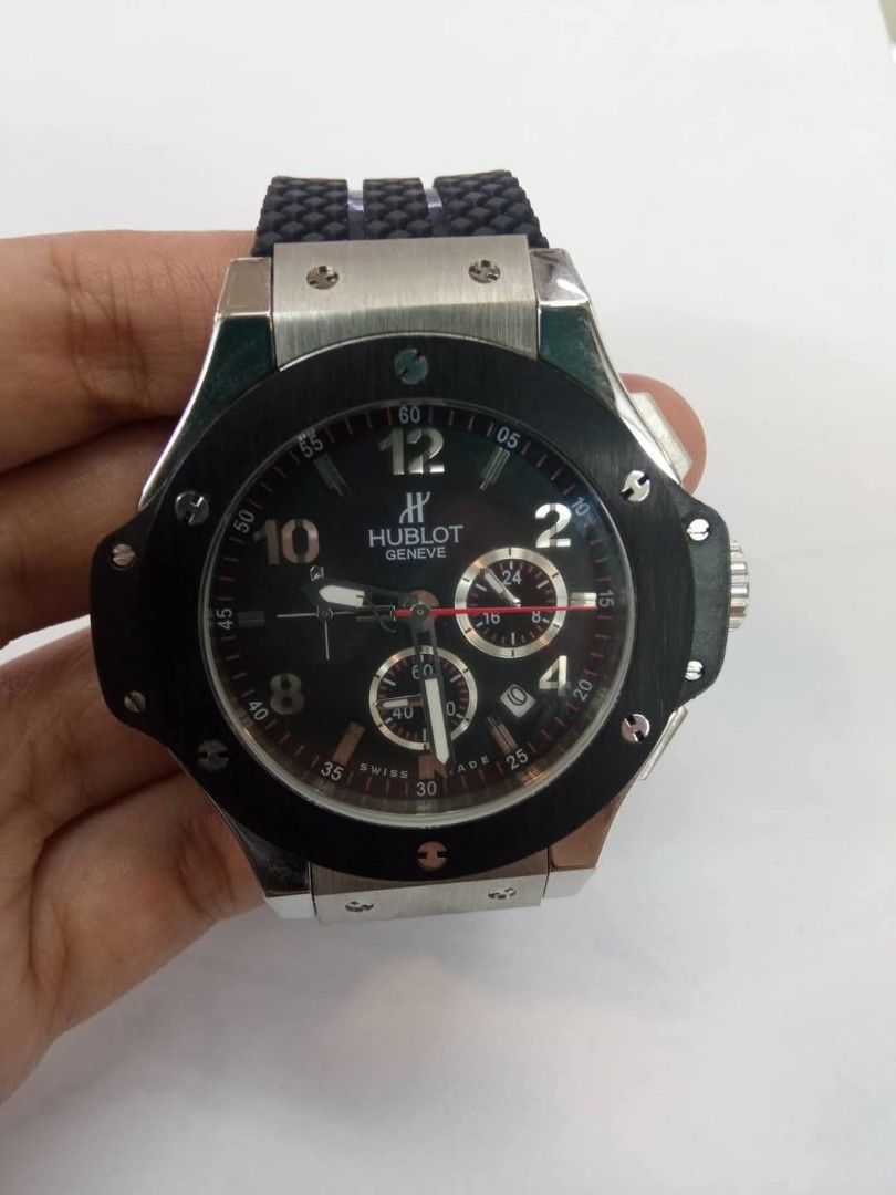 Hublot Geneve Chronograph Watch Rubber Strap (Category: Luxury Watches) located in Las Pinas. Submitted by teampeewee888 (Listing ID 1470023426, Image 2). Description: - Brand: Hublot Geneve - Type: Chronograph wristwatch - Dial: Black carbon-style with contrasting Arabic numerals and 3 sub-dials - Date Display: Positioned between 4 and 5 o'clock - Strap: Textured black rubber strap with deployment clasp - Bezel: Round black bezel with signature 