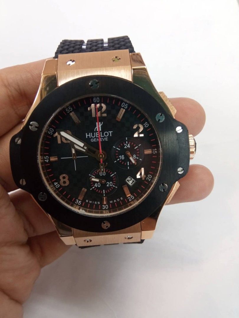 Hublot Geneve Chronograph Watch Rubber Strap (Category: Luxury Watches) located in Las Pinas. Submitted by teampeewee888 (Listing ID 1470023426, Image 1). Description: - Brand: Hublot Geneve - Type: Chronograph wristwatch - Dial: Black carbon-style with contrasting Arabic numerals and 3 sub-dials - Date Display: Positioned between 4 and 5 o'clock - Strap: Textured black rubber strap with deployment clasp - Bezel: Round black bezel with signature 
