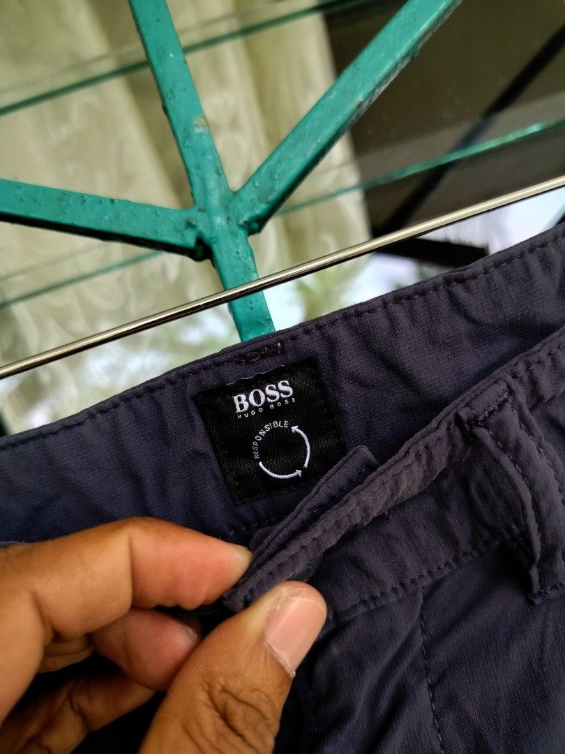 HUGO BOSS Dark Blue Pants Size 31/32 (Category: Trousers) located in Manila. Submitted by virgiliosa38485 (Listing ID 1470000955, Image 2). Description: - Brand: Hugo Boss (Responsible Collection) - Color: Dark blue - Size Waist 32-33 -Length 41.5 -Leg Opening /Hem 7.5 - Details: Branded buttons, custom coin pocket hardware, and contrast branding badge - Closure: Standard waist with zip fly - Condition: Clean fabric texture.