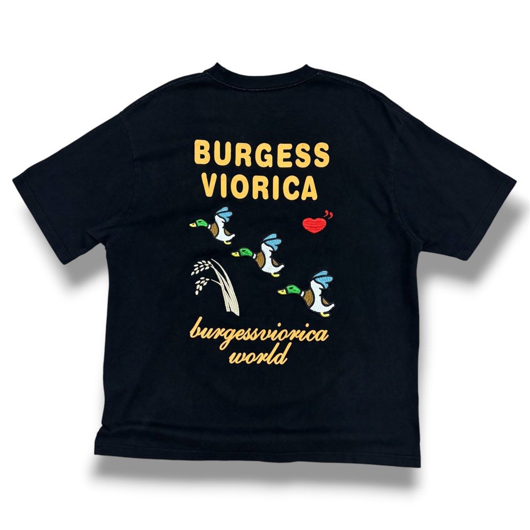 Human Made vibes (Category: Tshirts & Polo Shirts ) located in Quezon City. Submitted by grailph (Listing ID 1470064309, Image 1). Description: - Brand: Body Armour - Color: Black - Dimensions: 24”x 30” - Fit: Standard fit, crew neck, short sleeves - Front Detail: Embroidered red heart on the chest - Back Detail: Large yellow "Burgess Viorica" text with embroidered ducks and grain graphic - Style: Clean streetwear piece with premium embroidery Co