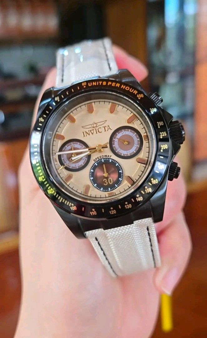 Invicta Speedway Chronograph Quartz Watch (Category: Men's Watches) located in Paranaque City. Submitted by araaj (Listing ID 1470134419, Image 1). Description: - Brand: Invicta Speedway Chronograph Watch - Case: Black stainless steel with tachymeter bezel (units per hour markings) - Dial: Champagne dial with three sub-dials, clear crystal, and gold-toned hands/markers - Strap: Textured white strap with stylish black stitching - Movement: Reliabl