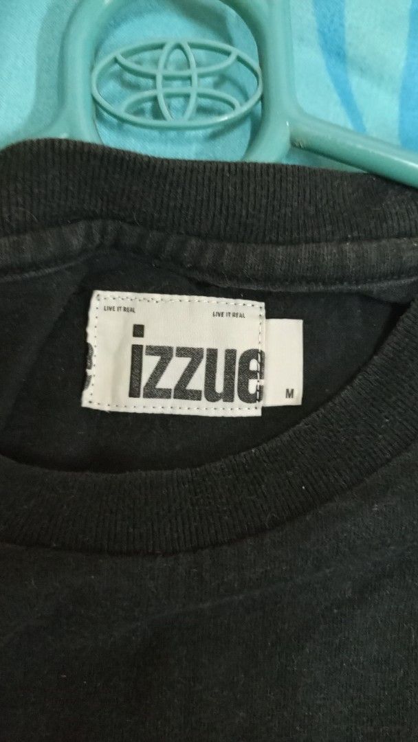 Izzue Black T-Shirt Size M (Category: Tshirts & Polo Shirts ) located in Manila. Submitted by rizu09 (Listing ID 1470039896, Image 2). Description: - Brand: Izzue - Color: Black - Size: Medium - Design: Iridescent graphic print with lightning bolt on chest; large numbers and lettering on the back - Fit: Short sleeves, crew neck, straight hem - Condition: Excellent / Great for .