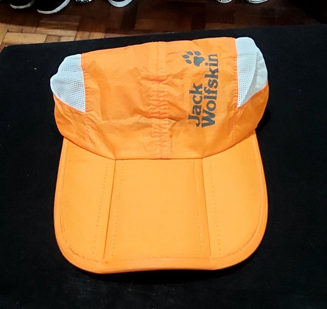 Jack Wolfskin Orange Mesh Outdoor Cap (Category: Caps & Hats) located in Legazpi City. Submitted by street_uniform (Listing ID 1470027077, Image 1). Description: - Issue Cut Tag. - Brand: Jack Wolfskin - Color: Bright orange with white mesh side panels - Design: Iconic paw logo printed on the front - Comfort: Lightweight material with a clean white sweatband lining - Fit: Adjustable strap at the back with a secure metal slider - Ideal for: Outdoo