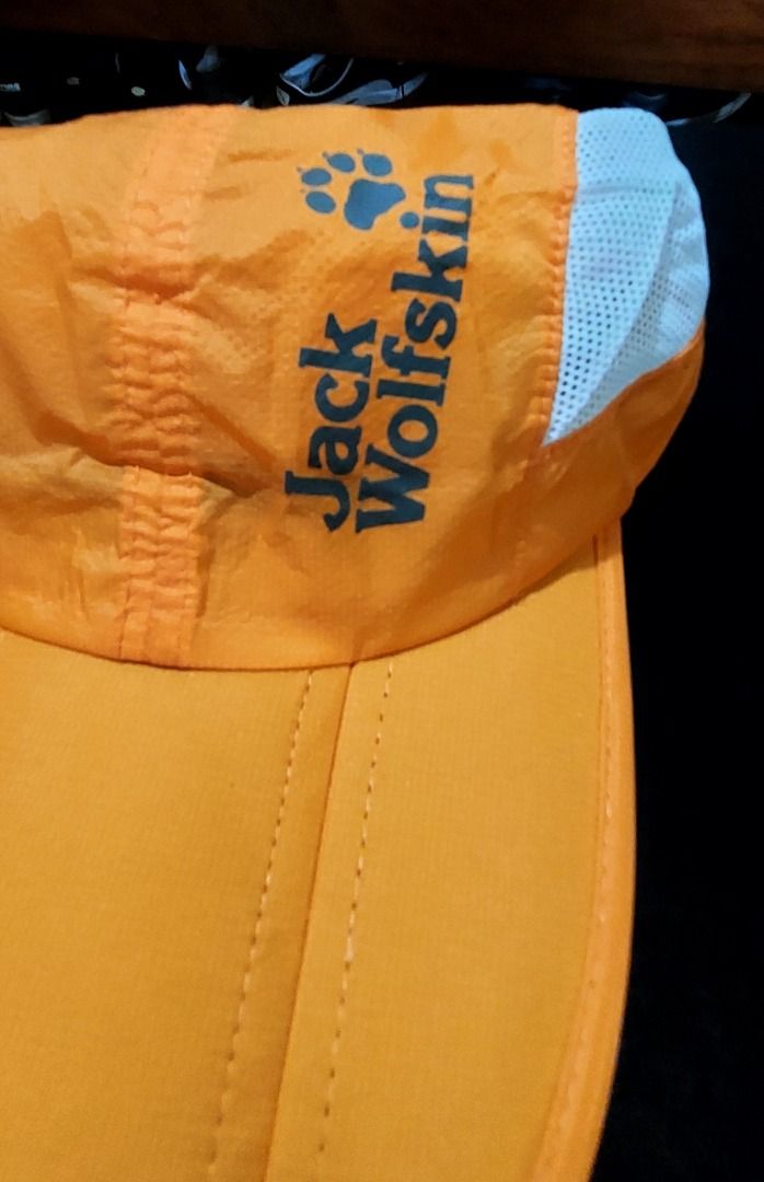 Jack Wolfskin Orange Mesh Outdoor Cap (Category: Caps & Hats) located in Legazpi City. Submitted by street_uniform (Listing ID 1470027077, Image 2). Description: - Issue Cut Tag. - Brand: Jack Wolfskin - Color: Bright orange with white mesh side panels - Design: Iconic paw logo printed on the front - Comfort: Lightweight material with a clean white sweatband lining - Fit: Adjustable strap at the back with a secure metal slider - Ideal for: Outdoo