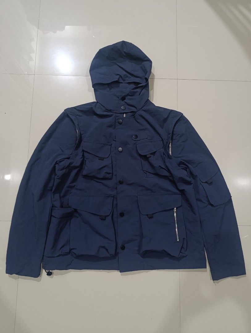 JASPAL Navy Blue Utility Nylon Hooded Jacket (Category: Coats, Jackets and Outerwear) located in Davao. Submitted by idioticthrifter (Listing ID 1470123913, Image 1). Description: - Brand: JASPAL - Color: Navy Blue - Size: L (Tag on collar) - Material: 100% Nylon - Features: Multiple front cargo pockets, snap button closures, shoulder zipper details, and attached hood - Condition: Clean fabric with clear branding and care tags - Style: Functional
