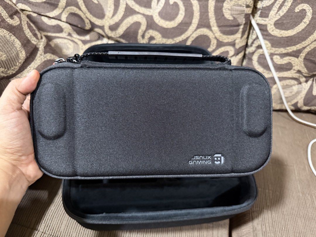 JSAUX Gaming Large Capacity Storage Carry Case (Category: Cases & Covers) located in Taguig. Submitted by ben_fermin (Listing ID 1470057708, Image 3). Description: -Brand New. Hindi nagamit. Nabenta na Switch 2. - Authentic JSAUX Gaming Storage Bag (Black) - Durable hard shell exterior with a sturdy top handle and smooth dual zippers - Spacious interior with customizable compartments and a mesh top lid pocket - Perfect for organizing gaming conso