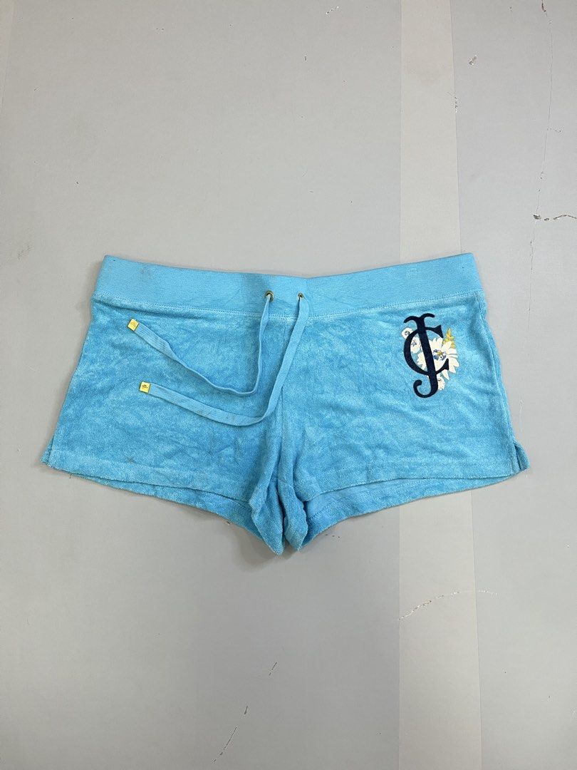Juicy Couture Blue Terrycloth Logo Shorts (Category: Shorts) located in Mabalacat. Submitted by aas_thriftfings (Listing ID 1470102986, Image 1). Description: - Brand: Juicy Couture - Color: Bright blue - Material: Soft and comfortable terrycloth - Waistband: Drawstring with gold-tone hardware - Pockets: Back flap pockets with gold snap buttons - Details: Floral rhinestone J logo embroidered on the front leg - Style: Casual loungewear - Mode of P