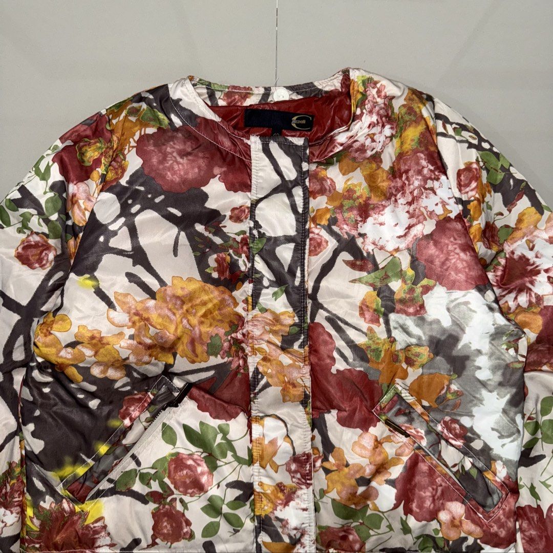 Just Cavalli multi-color floral jacket (Category: Luxury Apparel) located in Calasiao. Submitted by jafaith_man (Listing ID 1470081195, Image 2). Description: Just Cavalli multi-color floral quilted bomber/puffer jacket. It showcases the brand’s signature high-energy aesthetic, pairing a traditional quilted construction with a rich, abstract botanical print filled with deeply saturated red, orange, and gold tones. Size 40 Length 23.5 in. Width 21