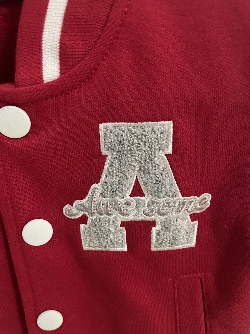 Justkids Red and Grey Varsity Jacket Size 3T (Category: Babies & Kids Fashion) located in San Luis. Submitted by auroraben (Listing ID 1470073144, Image 2). Description: - Brand: Justkids - Size: 3T - Color: Red and grey with white striped ribbing - Material: Soft sweatshirt fabric - Details: Large chenille 'A' patch with cursive embroidery, snap button closure, and two side pockets - Mode of Payment: GCash, BPI.