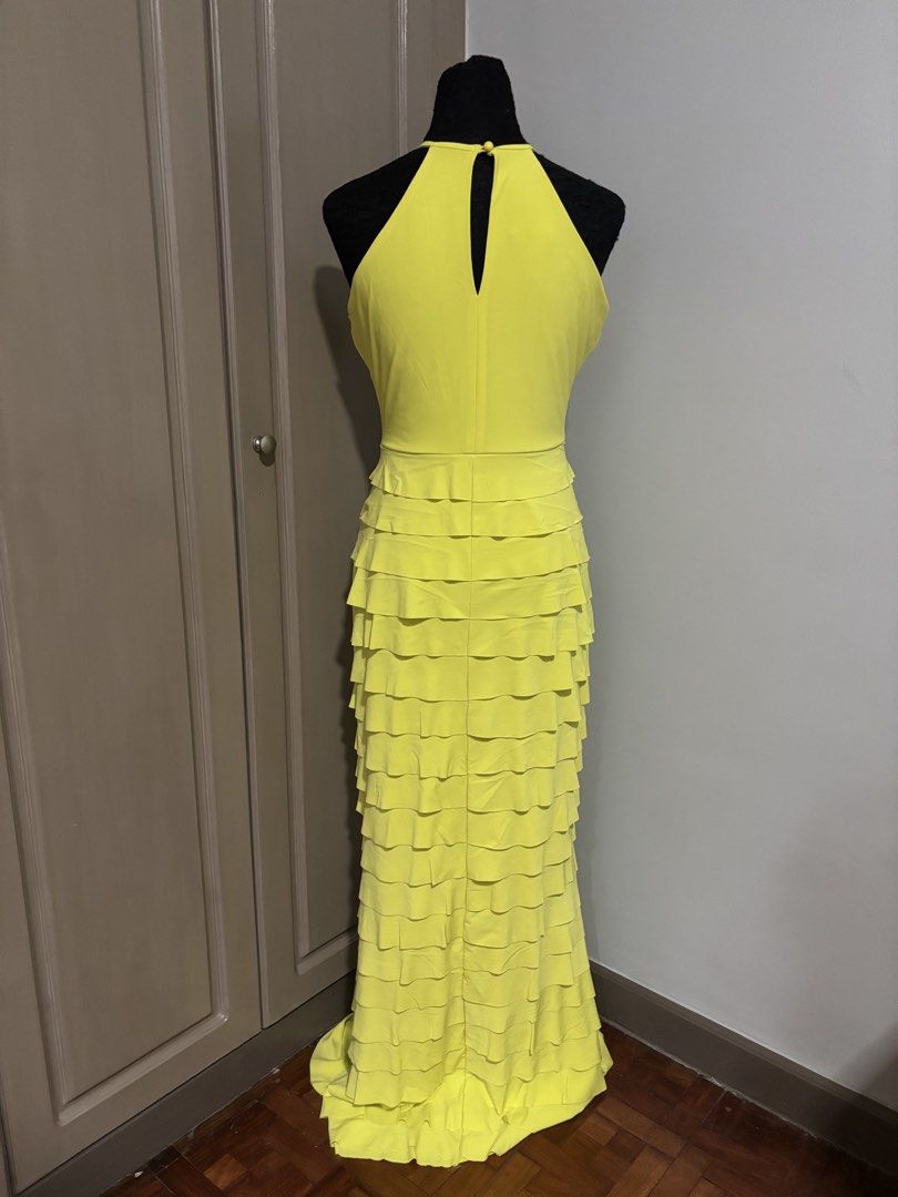 Karimadon Yellow Halter Ruffle Gown (Category: Dresses) located in Quezon City. Submitted by ada_412 (Listing ID 1470128733, Image 2). Description: - Brand: Karimadon - Size: Medium - Color: Bright Yellow - Style: Halter neckline with back keyhole button closure, fitted bodice, and floor-length layered ruffles - Material: Smooth, stretchy fabric - Condition: Excellent.