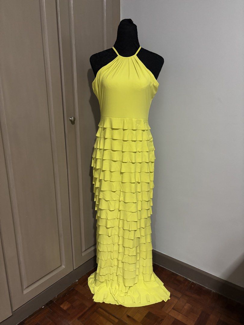 Karimadon Yellow Halter Ruffle Gown (Category: Dresses) located in Quezon City. Submitted by ada_412 (Listing ID 1470128733, Image 1). Description: - Brand: Karimadon - Size: Medium - Color: Bright Yellow - Style: Halter neckline with back keyhole button closure, fitted bodice, and floor-length layered ruffles - Material: Smooth, stretchy fabric - Condition: Excellent.