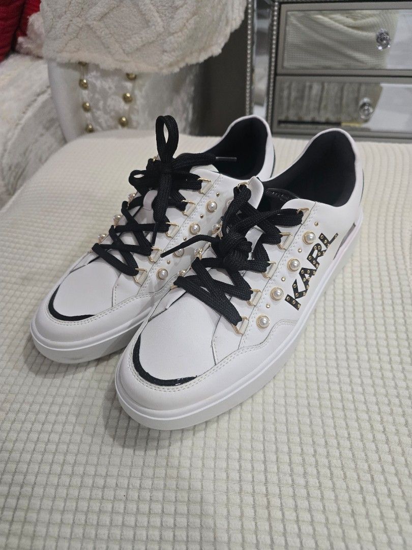 Karl Lagerfeld White Sneakers with Pearl Studs (Category: Sneakers) located in Santo Tomas. Submitted by bonita0219 (Listing ID 1470008433, Image 2). Description: - Brand: Karl Lagerfeld - Material: White leather - Details: Black thick laces, black heel tab, and gold side logo framed with pearl studs - Condition: Clean white soles with minimal wear visible - Style: Great casual sneakers for everyday outfits Size 11.5 womens.