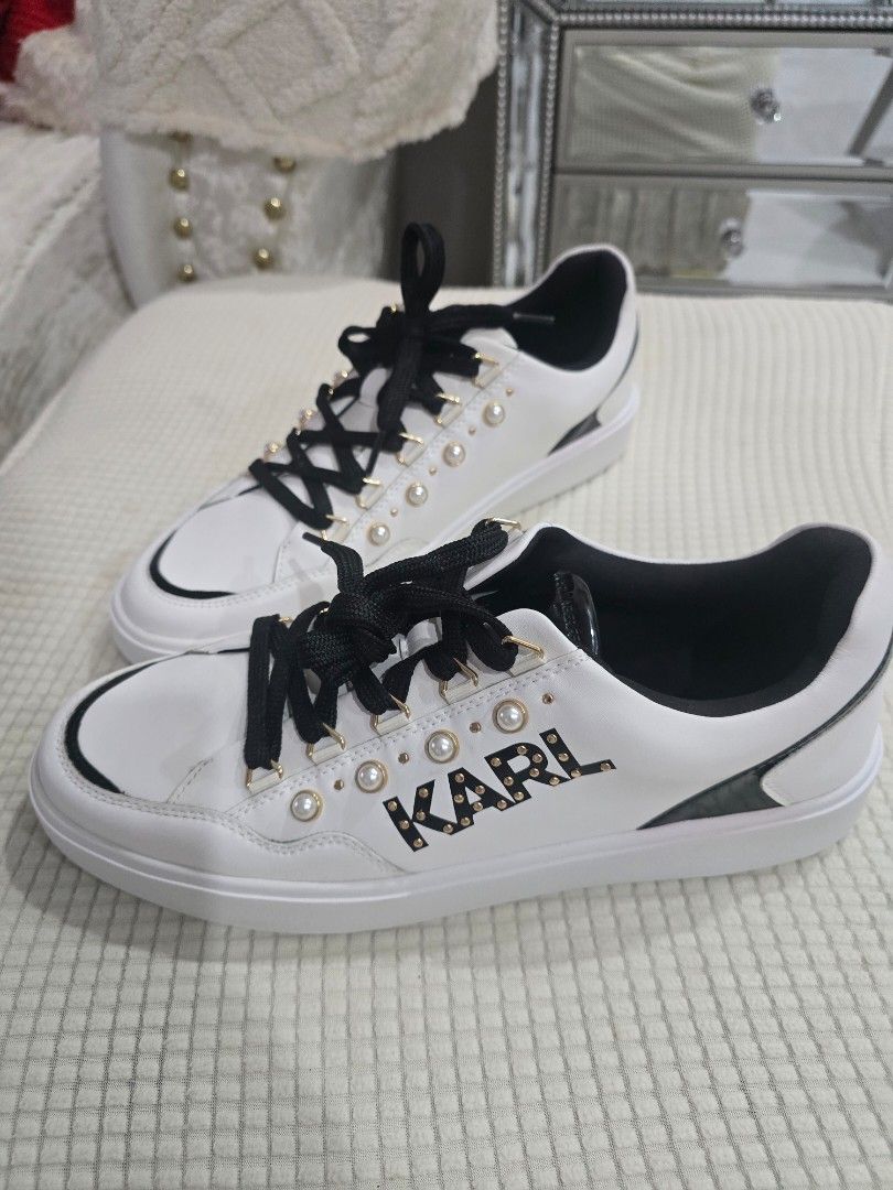 Karl Lagerfeld White Sneakers with Pearl Studs (Category: Sneakers) located in Santo Tomas. Submitted by bonita0219 (Listing ID 1470008433, Image 1). Description: - Brand: Karl Lagerfeld - Material: White leather - Details: Black thick laces, black heel tab, and gold side logo framed with pearl studs - Condition: Clean white soles with minimal wear visible - Style: Great casual sneakers for everyday outfits Size 11.5 womens.