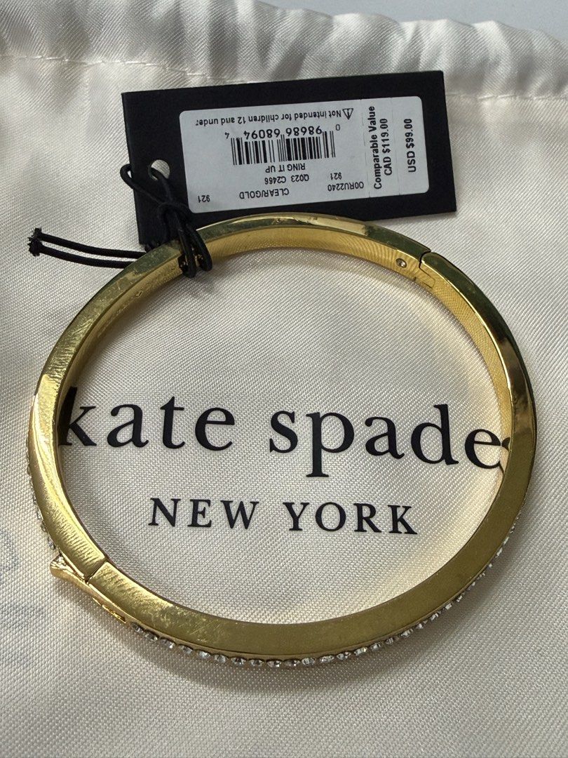 Kate Spade Ring It Up Pave Bangle Gold (Category: Bracelets) located in Quezon City. Submitted by bekyas_closet (Listing ID 1470089477, Image 1). Description: - Brand: Kate Spade - Condition: Brand new - Material/Design: Gold-tone metal with a row of sparkling clear stones on the outer edge - Closure: Hinged with a secure clasp - Model Number: O0RU2240 - Colorway: Clear / Gold - Inclusion: Comes with a white dust pouch.