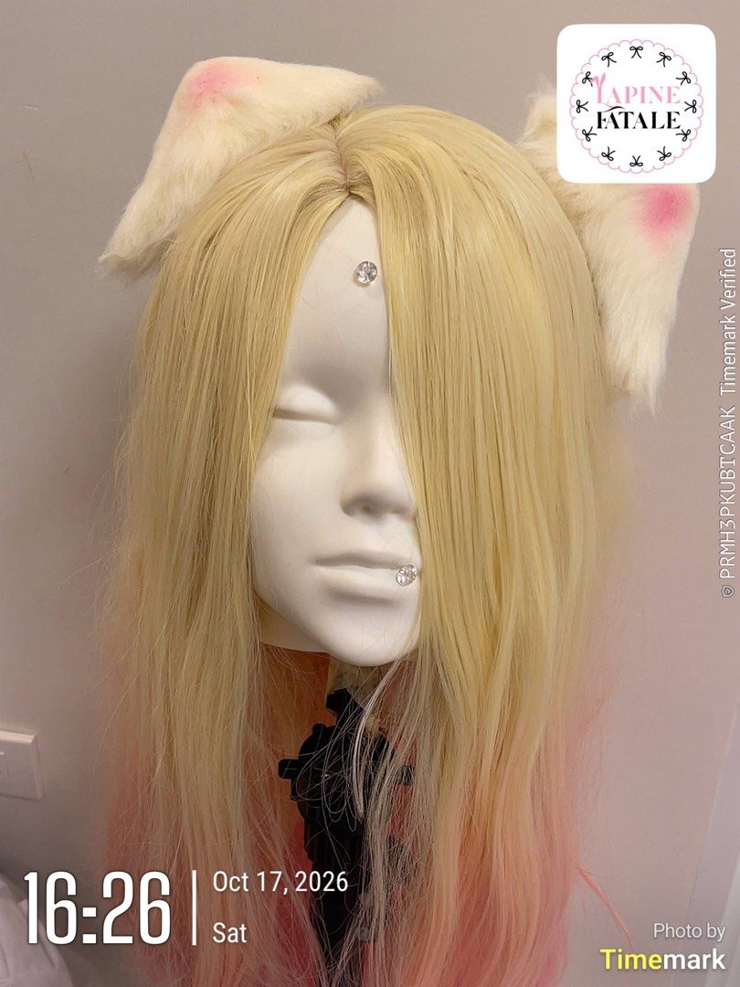 KDA All Out Ahri Cosplay Wig + Ears (Category: Hair Accessories) located in Bacolod City. Submitted by mariowos (Listing ID 1470003373, Image 1). Description: - Style: Long straight blonde and pink gradient wig - Features: Cute attached cat ears with pink inner shading and adhesive face jewels - Condition: Brand new, styled on mannequin - Perfect for: Cosplay, costume parties, anime conventions, and photoshoots - Easy to wear and maintain.