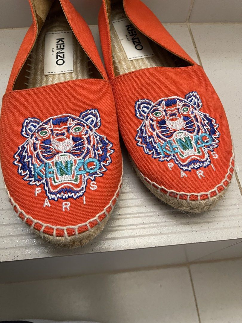 Kenzo Tiger Espadrilles Orange (Category: Flats & Sandals) located in Daraga. Submitted by freestyleselections (Listing ID 1470016164, Image 2). Description: - Brand: Kenzo - Color: Vibrant orange - Design: Iconic embroidered tiger graphic with KENZO PARIS lettering - Material: Canvas upper with jute rope braided soles and white whipstitching - Features: Easy slip-on design, interior fabric lining with brand tags - Condition: Clean soles with min