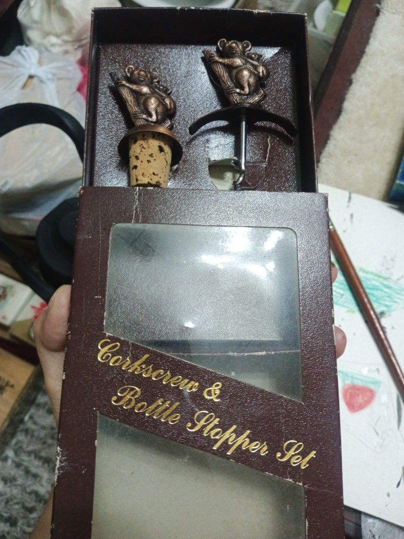 Koala Corkscrew and Bottle Stopper Set (Category: Vintage Collectibles) located in Manila. Submitted by christalyn94263 (Listing ID 1470117095, Image 1). Description: - Wine opener and bottle stopper set featuring a cute koala and baby koala design on tree branches - Elegant bronze-toned metallic finish - Includes a metal screw mechanism opener and a cork-attached bottle stopper - Packaged in an original brown presentation box with a clear plasti