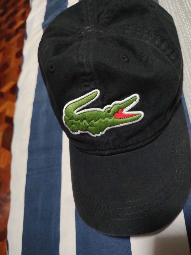 Lacoste Black Cap with Embroidered Crocodile Logo (Category: Caps & Hats) located in Manila. Submitted by snooks1938 (Listing ID 1470115857, Image 1). Description: Up For Sale.. 100% Legit or Money back.. - Authentic black Lacoste baseball cap - Large embroidered green and red crocodile logo on the front - Classic dad hat fit with a curved brim - Structured panels with eyelets for ventilation - Clean fabric and great for daily casual wear.