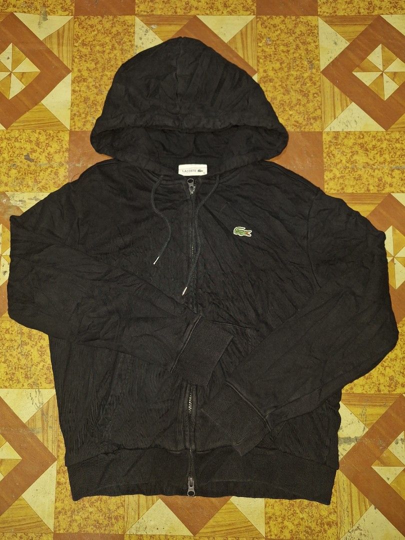 Lacoste Black Zip-Up Hoodie (Category: Coats, Jackets and Outerwear) located in Bago City. Submitted by thriftgarments0121 (Listing ID 1469995104, Image 1). Description: - Brand: Lacoste - Color: Classic Black - Material: Comfortable cotton blend - Design: Iconic embroidered green crocodile logo on the chest - Features: Standard front zip closure, adjustable drawstring hood, ribbed cuffs and hem - Mode of Payment: GCash, BPI, or Bank Transfer - S