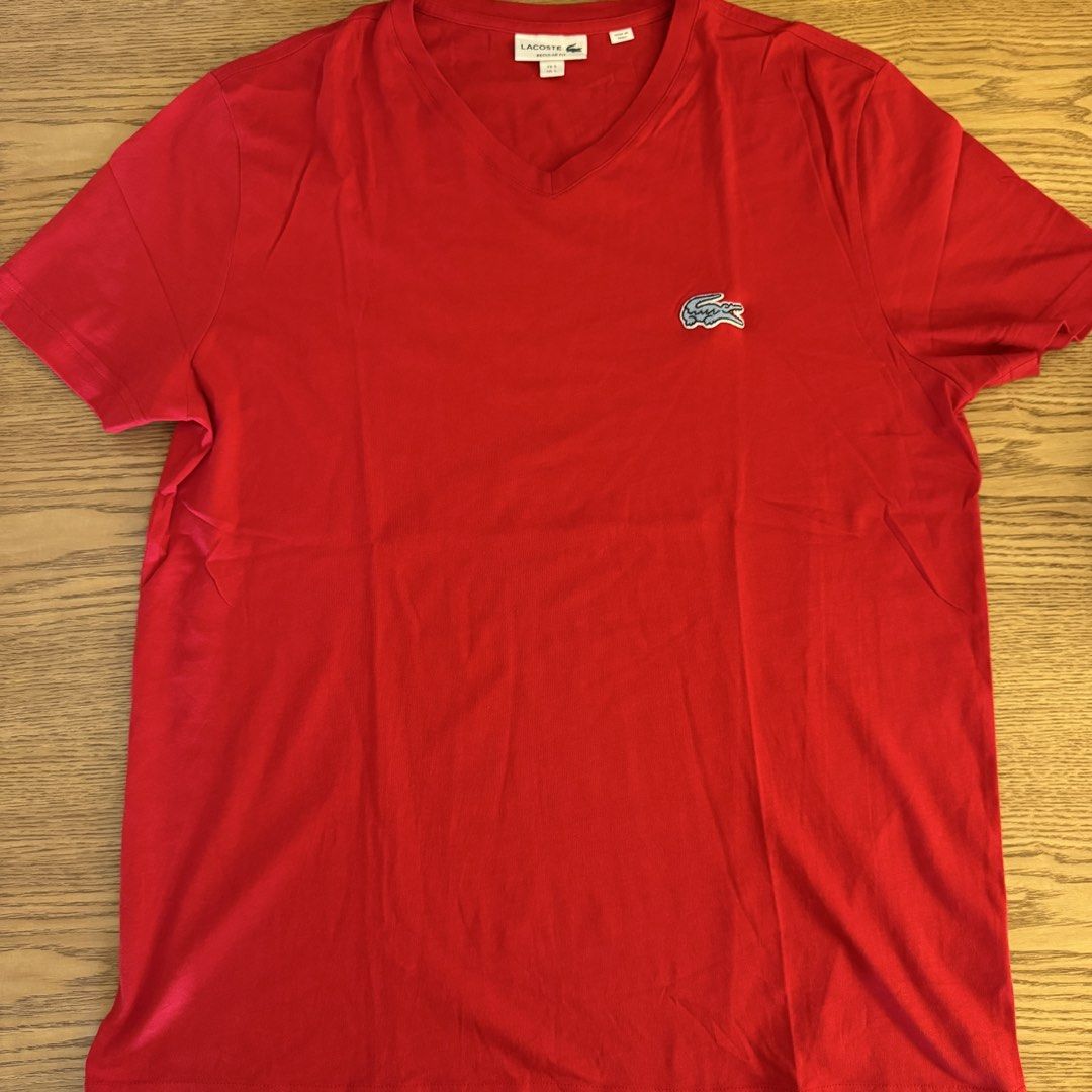 Lacoste Regular Fit V-Neck T-Shirt Red (Category: Tshirts & Polo Shirts ) located in Pasig City. Submitted by mon.alcantara (Listing ID 1469960137, Image 1). Description: - Brand: Lacoste - Color: Bright Red - Style: V-neck, short sleeves, regular fit - Logo: Iconic embroidered blue crocodile on the chest of around 10cm in length - Size: French Size 5 / US Large - Origin: Made in Peru - Condition: Clean fabric, vibrant color, well-maintained - Wa