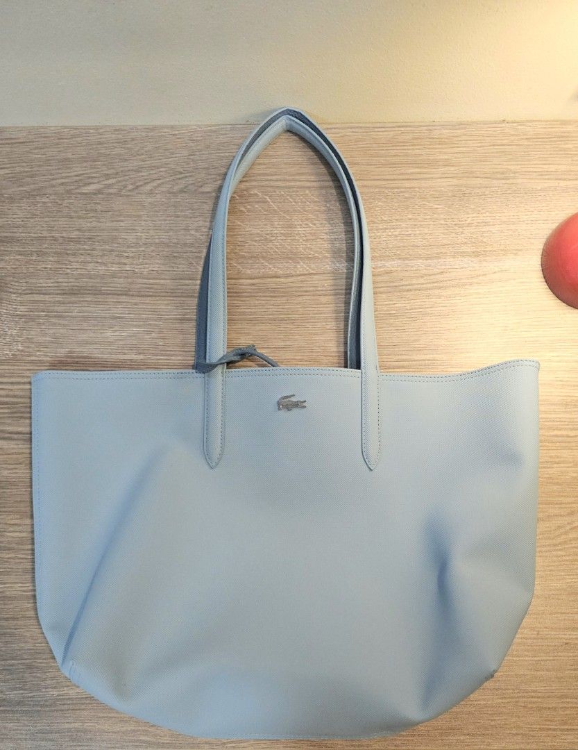 Lacoste Reversible Tote Bag Light Blue (Category: Tote Bags) located in Quezon City. Submitted by pjk2135 (Listing ID 1469969601, Image 1). Description: - Brand: Lacoste (100% authentic, bought from eastwood branch) -Bought last year for 7,450 PHP but selling for 7,300 PHP ONLY (still have the receipt) - Includes: Matching detachable zippered pouch - Condition: Like Brand New (only used twice) - Style: Reversible tote bag (Light Blue & Grey) RFS: