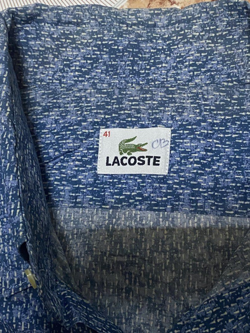 Lacoste Short Sleeve Button Down Shirt Size 41 (Category: Tshirts & Polo Shirts ) located in Navotas City. Submitted by vincent_mosqueriola (Listing ID 1470053754, Image 3). Description: - Brand: Lacoste - Type: Short sleeve button-down shirt - Size: 41 - Color: Blue with all-over textured dash pattern - Material: 100% lightweight cotton - Details: Standard collar, front chest pocket with embroidered crocodile logo - Style: Great casual piece for