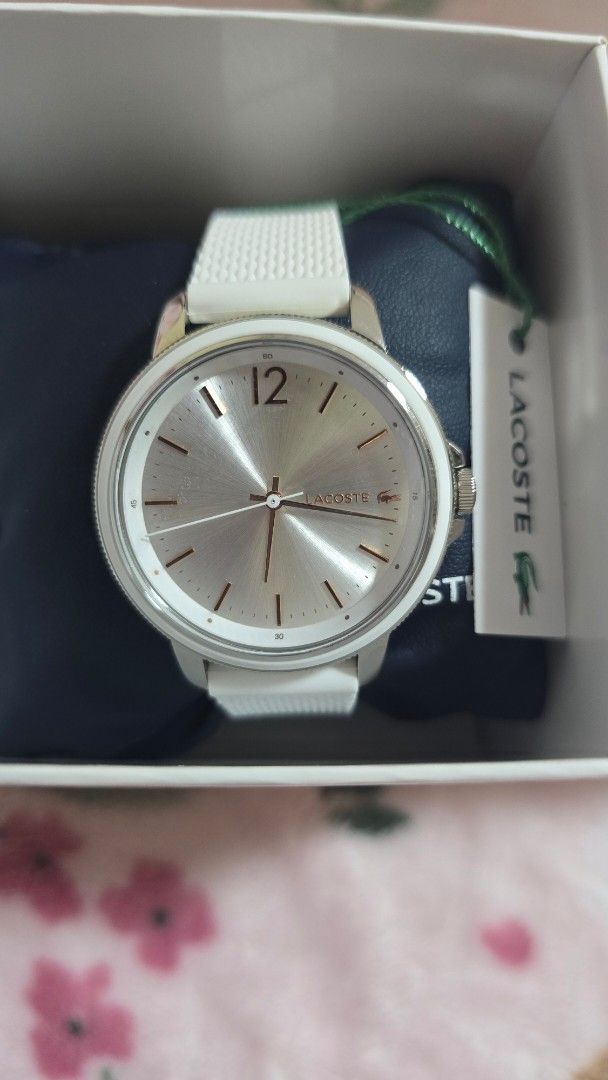 Lacoste White Watch 2001197 (Category: Luxury Watches) located in Quezon City. Submitted by impdc1130 (Listing ID 1470132818, Image 3). Description: White Lacoste watch, model 2001197. Silver sunray dial with rose gold accents and a prominent 12 o'clock marker. White textured silicone strap. Original white and navy presentation box included with store tags attached. Unworn condition, tags still on..