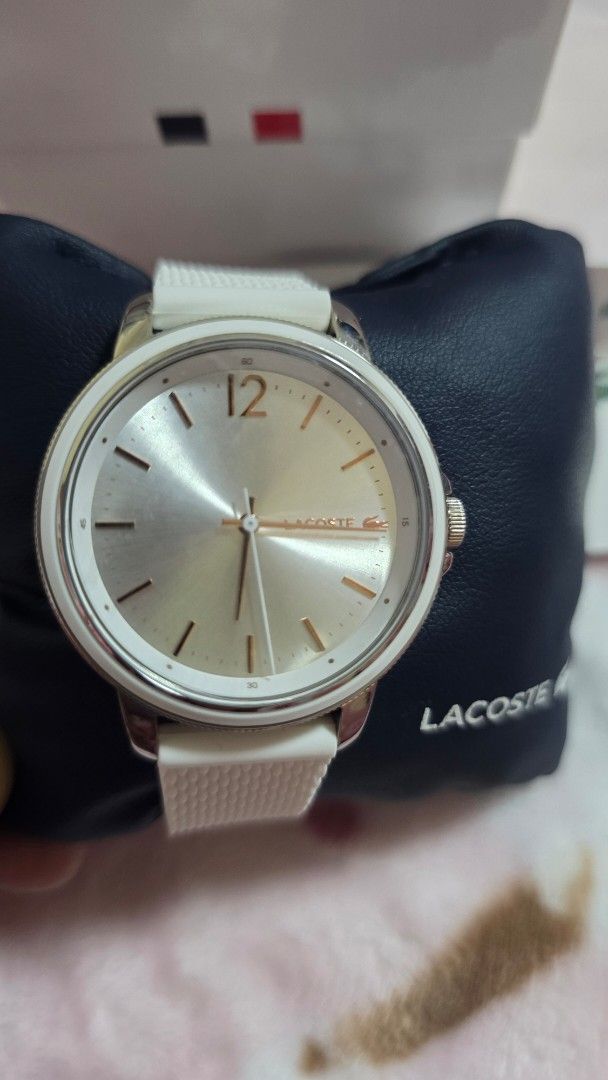 Lacoste White Watch 2001197 (Category: Luxury Watches) located in Quezon City. Submitted by impdc1130 (Listing ID 1470132818, Image 2). Description: White Lacoste watch, model 2001197. Silver sunray dial with rose gold accents and a prominent 12 o'clock marker. White textured silicone strap. Original white and navy presentation box included with store tags attached. Unworn condition, tags still on..