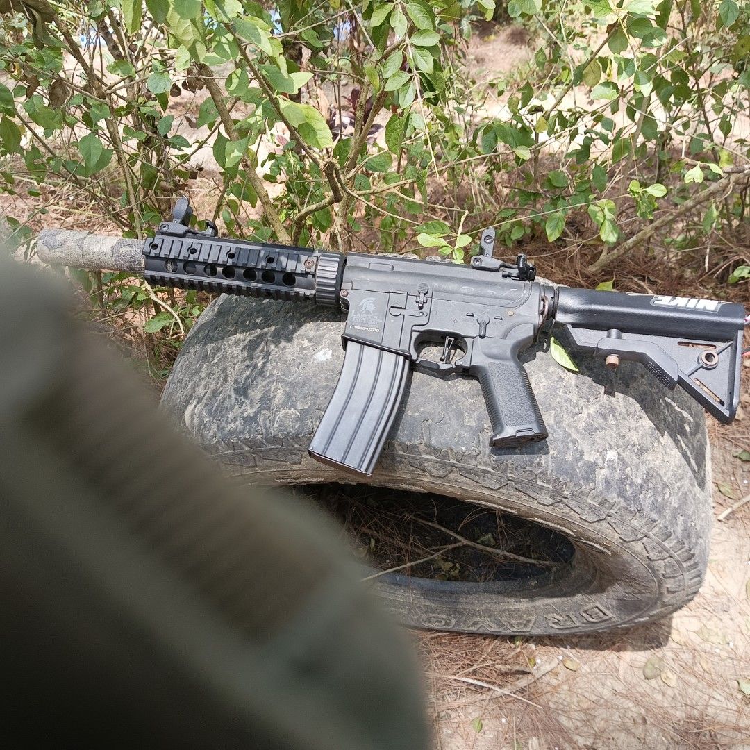 Lancer Tactical M4 Airsoft Rifle (Category: Action & Battle Toys) located in Caloocan City. Submitted by frenziedjack (Listing ID 1470072530, Image 2). Description: - Model: Lancer Tactical M4 rifle - Customization: Ghillie wrap and camo tape on the barrel Airsoft Lancer Tactical Gen 3 Inclusions - 1 metal Kalmot mag - 2 polymer mid-cap mags — ₱1,200 - Speedloader — ₱200 - 11.1V T-plug battery — ₱600 - Tan polymer magwell — ₱150 - Tan handguard r
