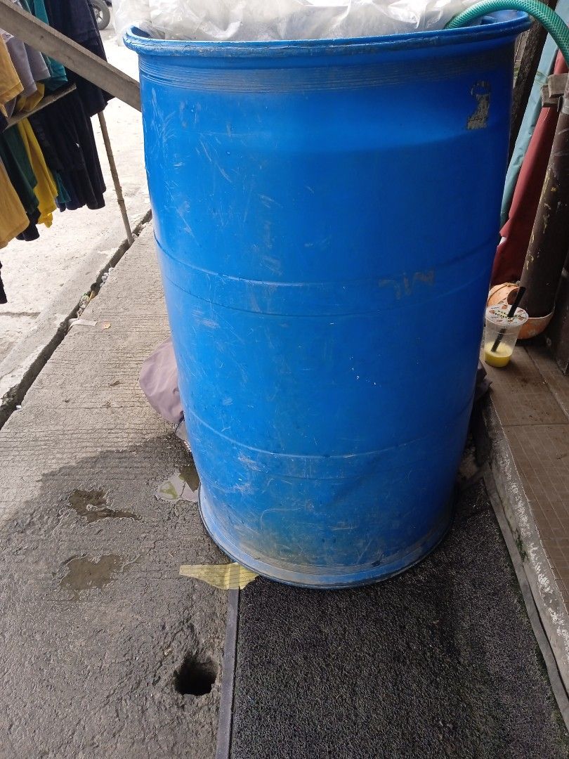 Large Blue Plastic Drum Container Water Storage (Category: Storage Boxes & Baskets) located in Manila. Submitted by dystuazon08573 (Listing ID 1470005362, Image 1). Description: - Type: Big blue plastic drum for water and liquids - Condition: Sturdy with visible scuffs and surface wear from previous use - Design: Open top style with white inner covering material and an attached green hose near the rim - Capacity: Large size - Best Uses: Ideal for