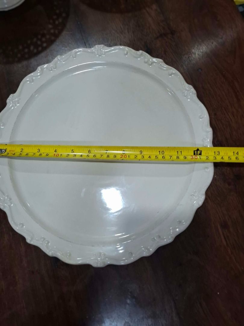 Large White Scalloped Serving Platter (Category: Dinnerware & Cutlery) located in Pasig City. Submitted by dripcounty (Listing ID 1470025881, Image 1). Description: Large White Scalloped Serving Platter ₱250 Bought in the Philippines Condition: Good / preloved Large white serving platter with decorative scalloped rim. Approximately 13 inches across, based on tape photo. Small surface marks visible. Actual item shown in photos. Delivery fee should