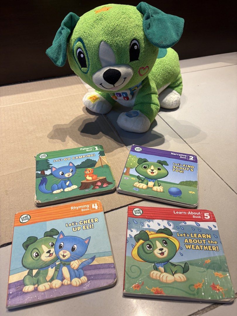 LeapFrog Scout Talking Plush Toy with 4 Mini Books (Category: Educational & Learning Toys) located in Angeles City. Submitted by slimshadee (Listing ID 1470077657, Image 1). Description: - Green LeapFrog Scout interactive plush dog with working collar buttons - Includes 4 matching mini board books: Let's Go Camping, Let's Find Scout's Toy!, Let's Cheer Up Eli!, and Let's Learn About the Weather! - Plush body is clean, soft, and fully intact - Boo