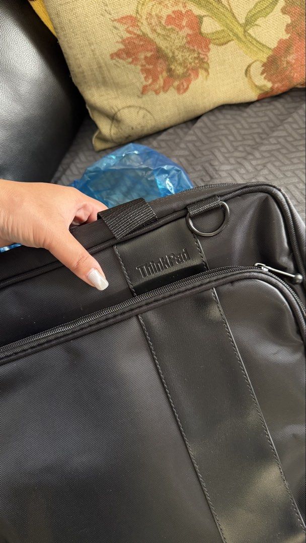 Lenovo ThinkPad Laptop Bag Briefcase (Category: Laptop Bags & Sleeves) located in Pasay City. Submitted by yssavibe14 (Listing ID 1470007143, Image 1). Description: - Brand/Model: Lenovo ThinkPad Laptop Bag - Color: Classic Black with Faux Leather Trim - Material: Durable fabric, clean inside and out - Storage: Front zippered pocket for chargers/cables + main compartment with internal dividers - Portability: Sturdy top handles and metal D-ring fo