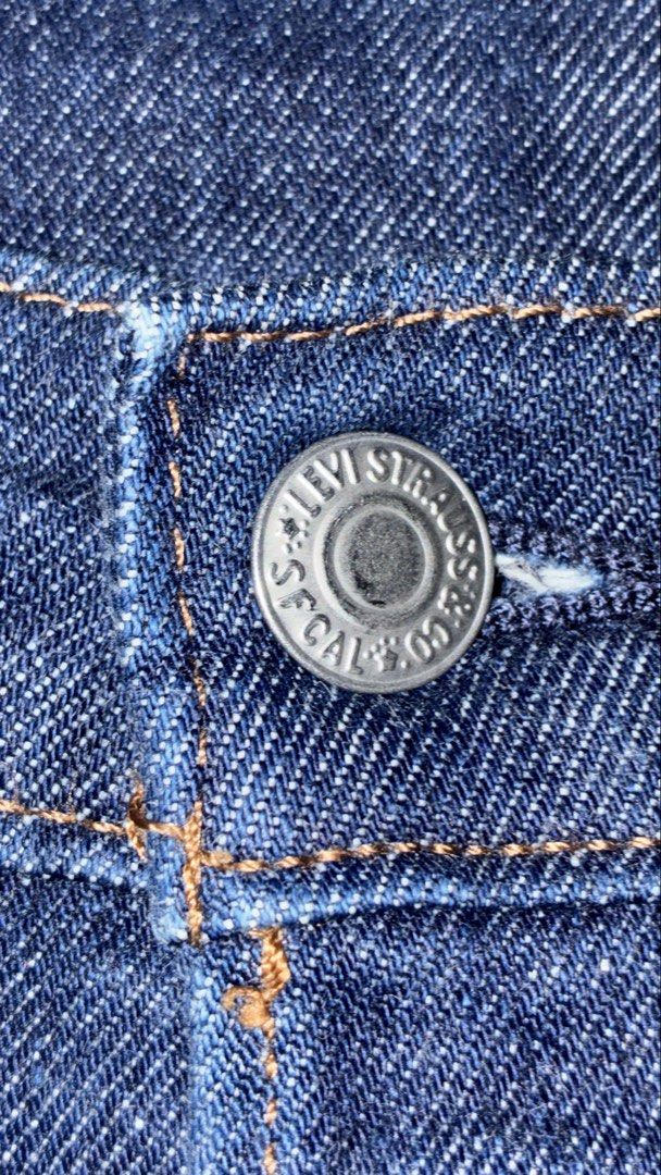 Levi Strauss & Co. Dark Wash Denim Jeans (Category: Jeans) located in Placer. Submitted by talaalond61563 (Listing ID 1469966768, Image 3). Description: - Brand: Levi Strauss & Co. - Wash: Dark indigo - Fit: Straight leg - Details: Classic 5-pocket setup, contrast stitching, branded metal buttons, and iconic red tab - Material: Sturdy twill fabric with visible diagonal weave texture - Condition: Excellent quality, versatile for any outfit.
