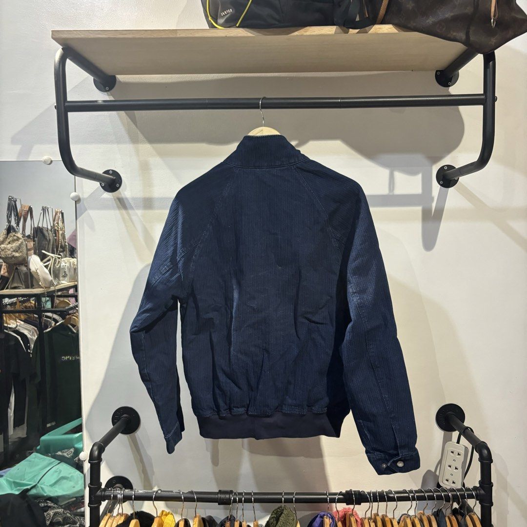 Levi Strauss & Co. Denim Jacket Size S (Category: Coats, Jackets and Outerwear) located in Bambang. Submitted by heats777 (Listing ID 1470003800, Image 3). Description: - Brand: Levi's - Size: Small - Color: Dark blue / Clean dark wash denim - Closure: Front zip up with stand collar and button closure - Pockets: Two secure zipped side pockets - Details: Ribbed hem and cuffs - Origin: Made in India.