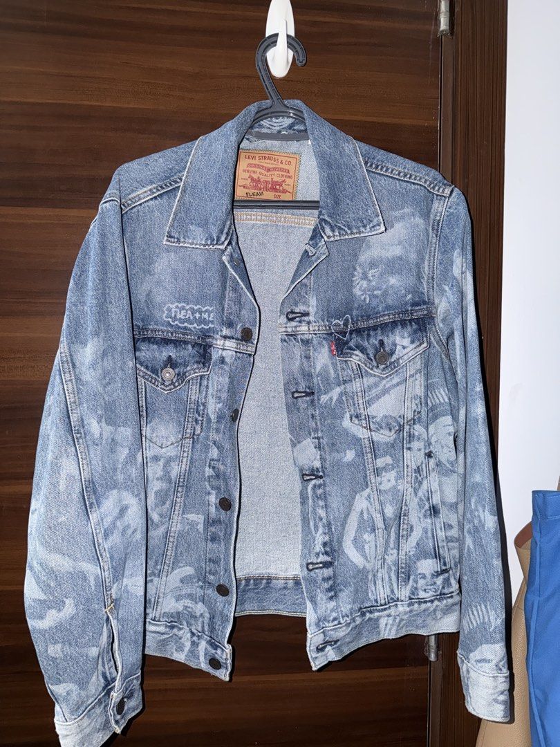 Levi's Fleavi Collab Denim Jacket (UNISEX) (Category: Coats, Jackets and Outerwear) located in Mandaluyong City. Submitted by kadynkelsey (Listing ID 1470037833, Image 1). Description: - Brand: Levi's - Size: S -Loose fit - Design: Loose fit Unique bleached all-over photo print wash covering front, back, and sleeves - Features: Classic button-up front, dual chest pockets, and collar - Material: Sturdy denim - Condition/Style: Great statement piec