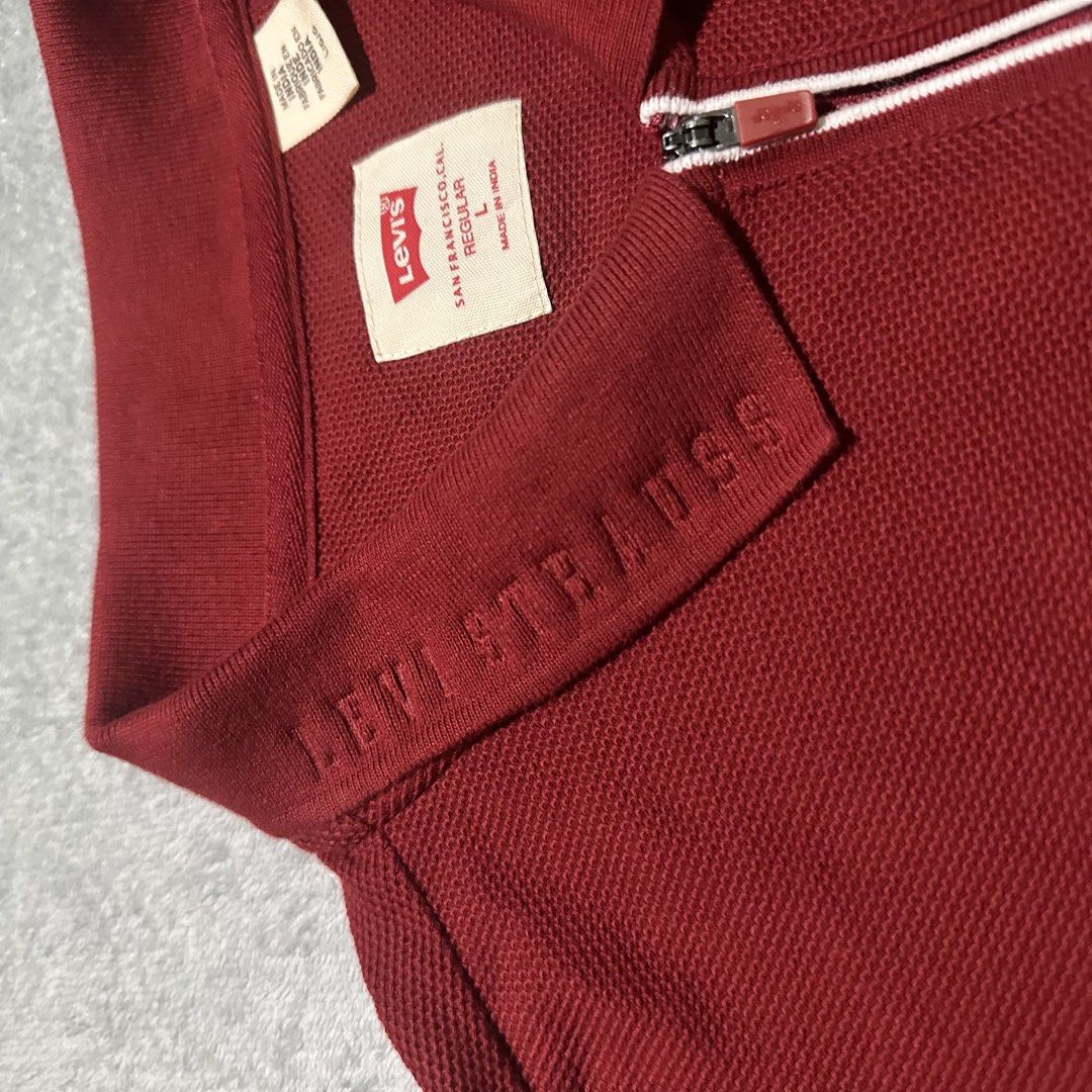 Levi's Red Half Zip Polo Shirt Size L (Category: Tshirts & Polo Shirts ) located in Bayombong. Submitted by rochelle_archive_garments (Listing ID 1470039625, Image 3). Description: - Brand: Levi's - Color: Rich Red - Size: Large (Regular Fit) - Material: Textured piqué knit fabric - Origin: Made in India - Design: Half-zip front closure with white trim and debossed collar lettering - Branding: Iconic red Levi's tab logo on the left chest and lowe