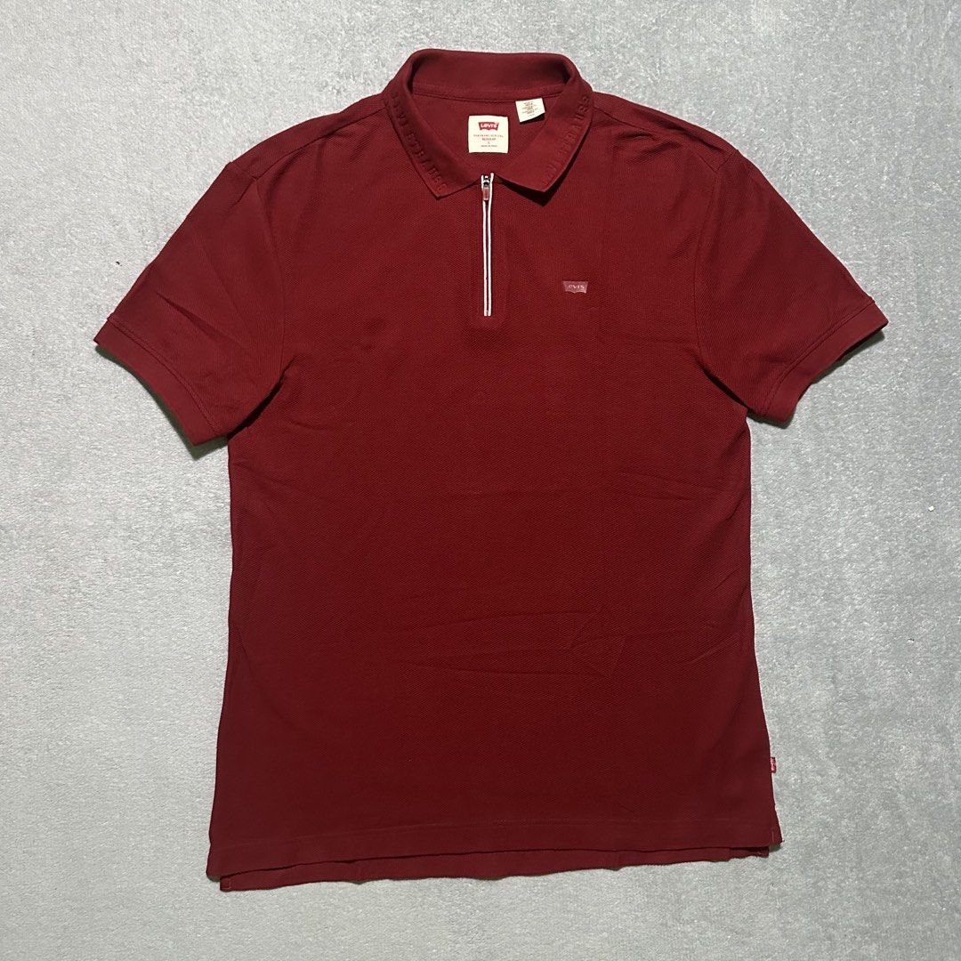 Levi's Red Half-Zip Polo Shirt Size L (Category: Tshirts & Polo Shirts ) located in Villaverde. Submitted by bakatzy_secondhand_garments (Listing ID 1470093651, Image 1). Description: - Brand: Levi's - Color: Dark Red - Size: L (Regular Fit) - Material: Textured pique cotton - Details: Half-zip neck with white contrast piping, embossed collar lettering, and red logo tabs - Origin: Made in India - Condition: Clean inside and out, all labels intact