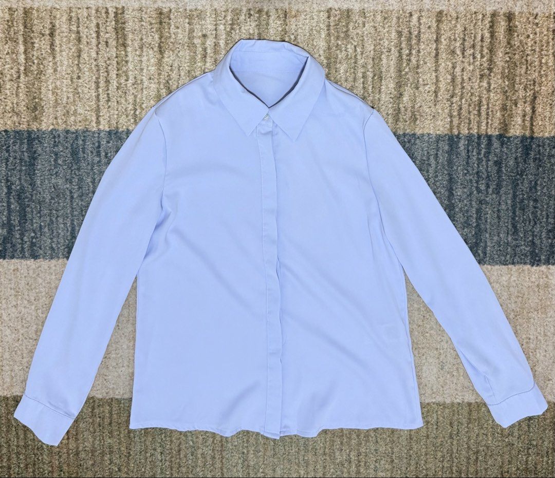 Light blue button-down long sleeve shirt (Category: Longsleeves) located in Manila. Submitted by jamie_closet (Listing ID 1469961210, Image 2). Description: - Light blue long sleeve blouse with a classic collar - Front button placket featuring hidden buttons - Made from smooth, lightweight material for all-day comfort - Versatile solid color design, easy to pair with trousers or skirts - Perfect for both workwear and casual days - Please check th