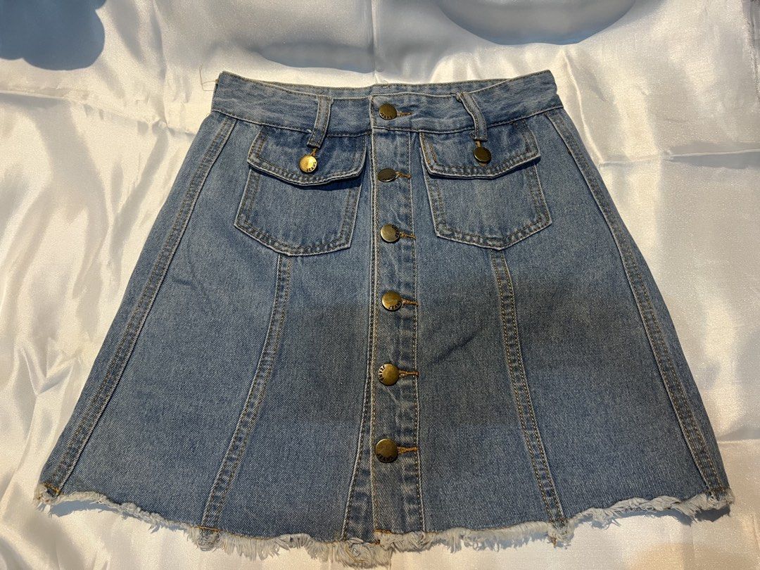 Light Blue Denim Skirt with Front Buttons and Pockets (Category: Skirts) located in Manila. Submitted by ghengdhoze (Listing ID 1470065674, Image 1). Description: - Style: Light wash denim A-line skirt - Details: Brass-tone front buttons, classic back yoke - Pockets: Two faux-chest style pockets near the waistband - Hem: Trendy raw frayed hemline - Fit: Structured panel seams for a flattering fit - Condition: Great casual piece for everyday outfi