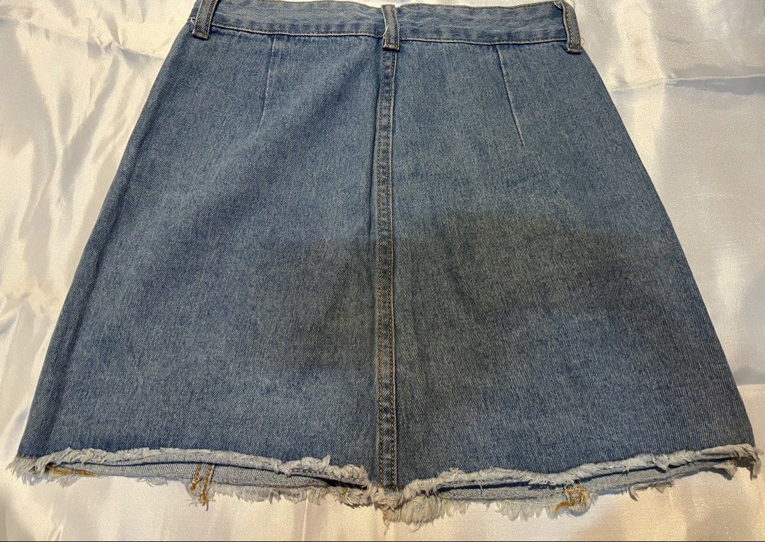 Light Blue Denim Skirt with Front Buttons and Pockets (Category: Skirts) located in Manila. Submitted by ghengdhoze (Listing ID 1470065674, Image 2). Description: - Style: Light wash denim A-line skirt - Details: Brass-tone front buttons, classic back yoke - Pockets: Two faux-chest style pockets near the waistband - Hem: Trendy raw frayed hemline - Fit: Structured panel seams for a flattering fit - Condition: Great casual piece for everyday outfi